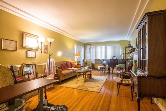 living room with crown molding and hardwood / wood-style floors