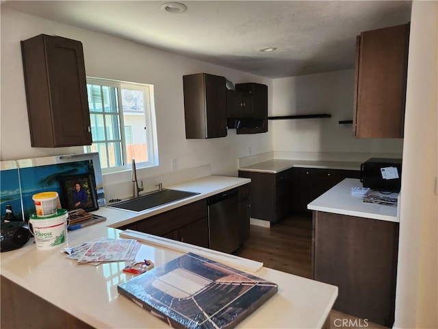 kitchen with sink, dark brown cabinets, dark hardwood / wood-style floors, and dishwasher