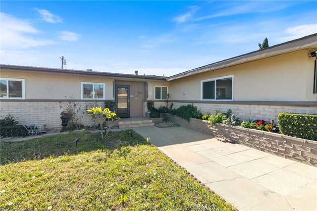 single story home featuring a patio and a front lawn