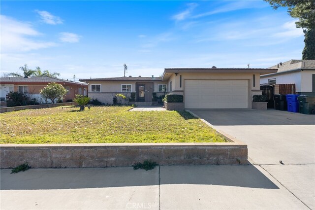 ranch-style home with a garage and a front lawn