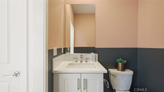 bathroom with toilet and vanity