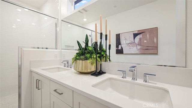 bathroom featuring tiled shower and vanity