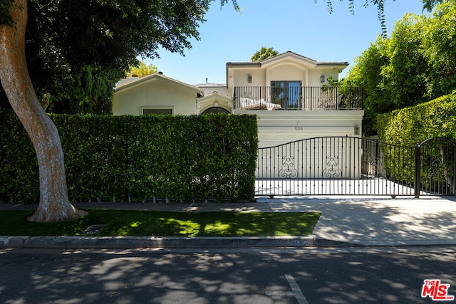 view of front of home with a balcony and a garage