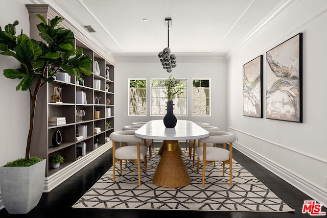 dining area featuring dark hardwood / wood-style floors, built in features, and crown molding