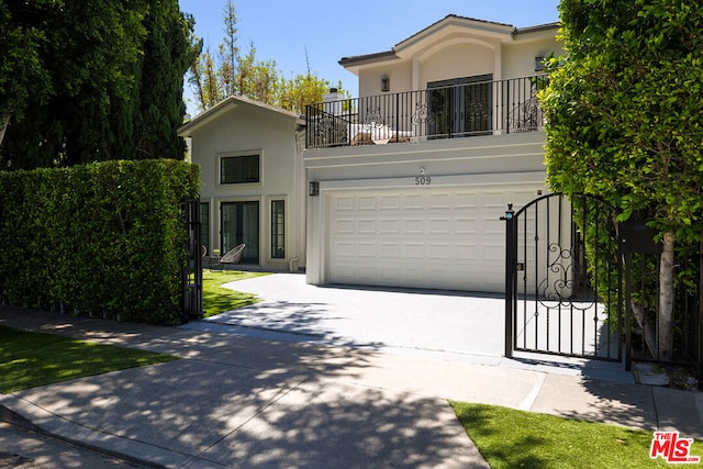 view of front of home with a garage and a balcony