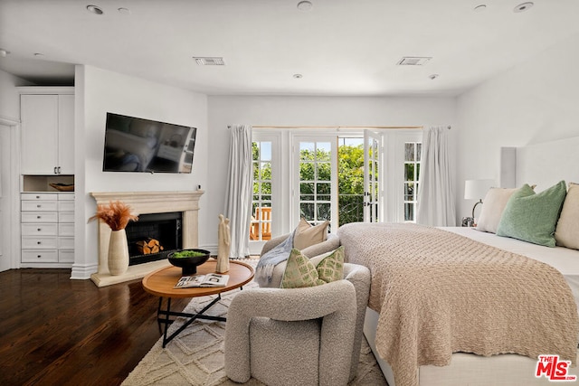 bedroom with access to exterior and hardwood / wood-style floors