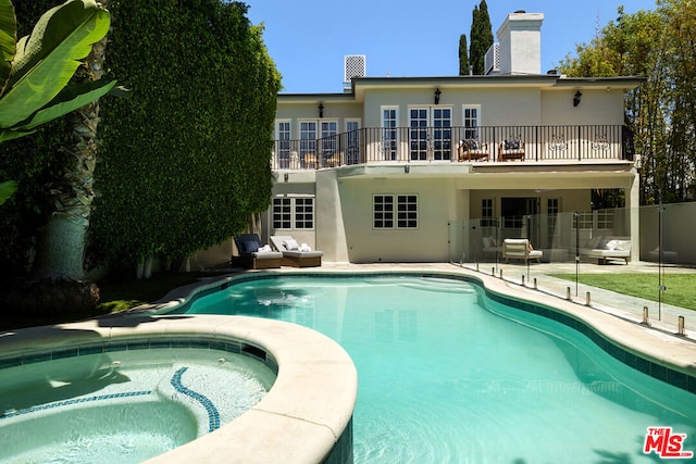 view of pool with a patio area and an in ground hot tub