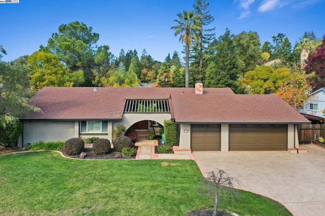 view of front of house featuring a balcony and a front lawn