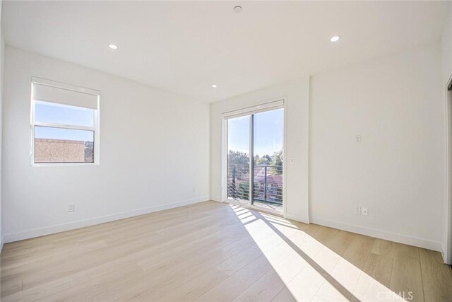 empty room with light hardwood / wood-style flooring