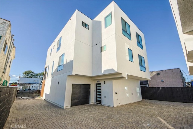 rear view of house featuring a garage