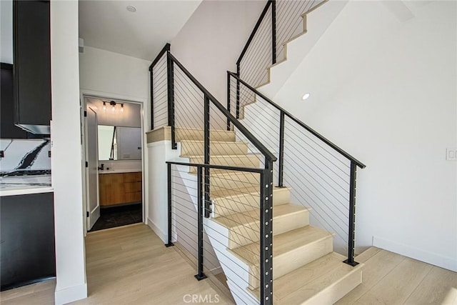 stairway with hardwood / wood-style floors