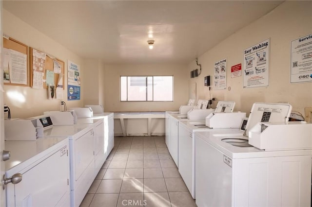 washroom featuring washing machine and dryer and light tile patterned floors