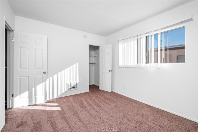 unfurnished bedroom featuring carpet and a closet