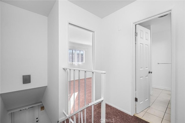 hall with light tile patterned floors