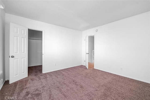 unfurnished bedroom featuring carpet and a closet