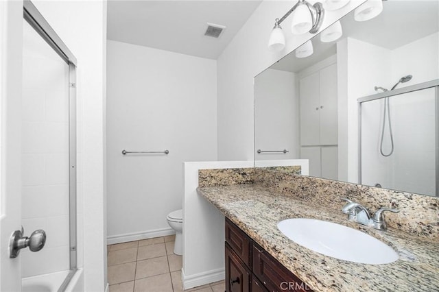 bathroom featuring tile patterned floors, toilet, and vanity