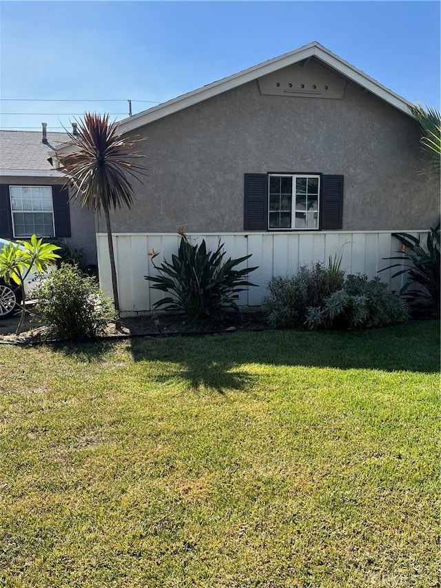 view of side of property with a lawn