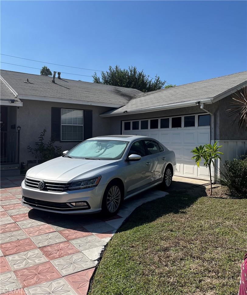 view of property exterior with a yard and a garage