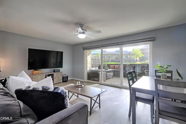 living room with ceiling fan and light wood-type flooring