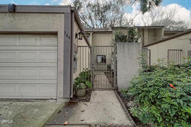 view of gate with a garage