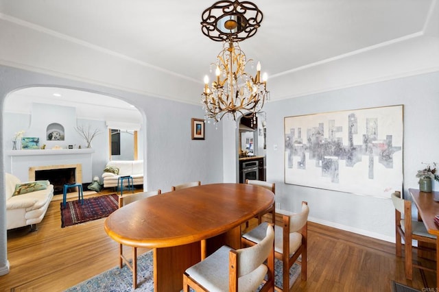 dining space with dark wood-type flooring and a notable chandelier