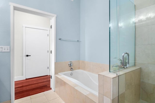 bathroom with tile patterned flooring and independent shower and bath