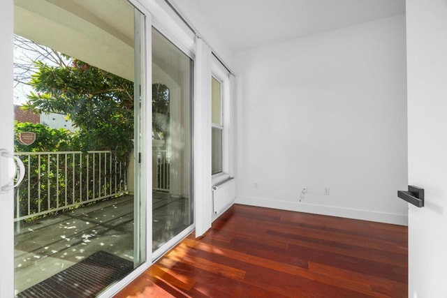 empty room with dark hardwood / wood-style flooring