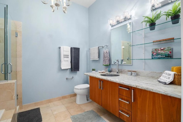 bathroom featuring tile patterned floors, toilet, a shower with door, and vanity