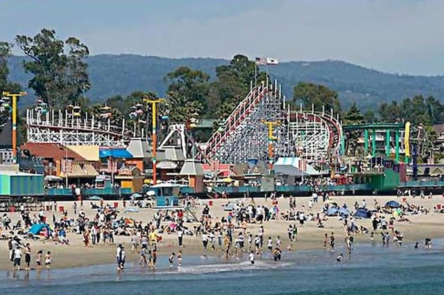 view of property's community with a water and mountain view and a beach view