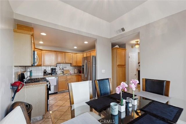 dining space featuring light tile patterned floors and sink