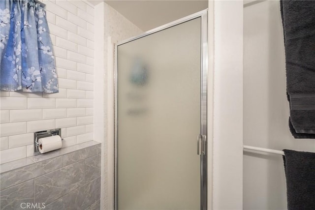 bathroom with a shower with shower door