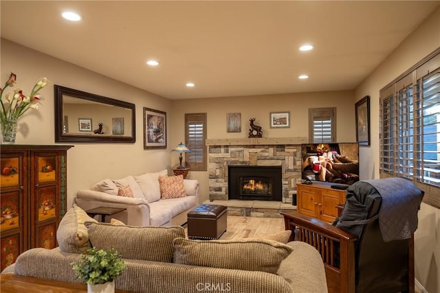 living room with light hardwood / wood-style floors and a fireplace