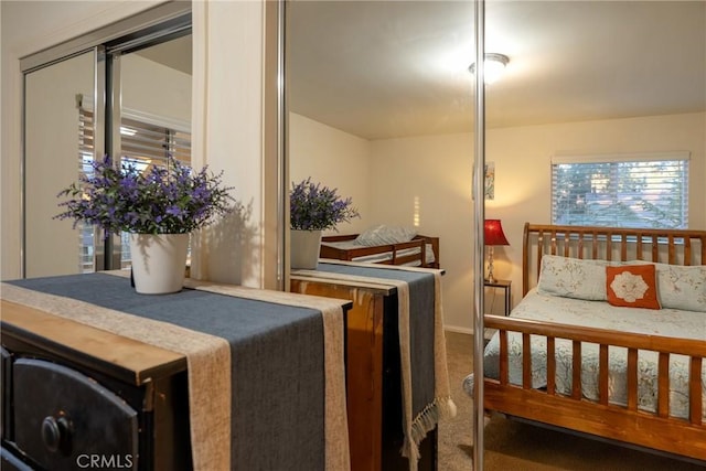 carpeted bedroom with multiple windows