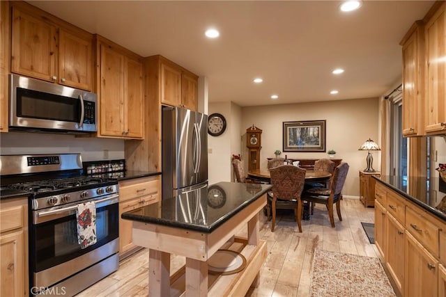 kitchen featuring appliances with stainless steel finishes and light hardwood / wood-style floors