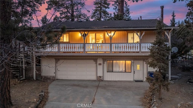 view of front of property with a garage and a balcony