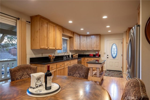 kitchen featuring light brown cabinetry, plenty of natural light, and appliances with stainless steel finishes