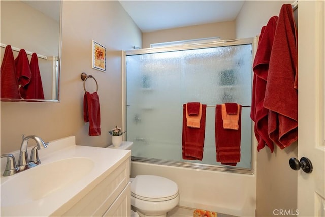 full bathroom with bath / shower combo with glass door, toilet, and vanity