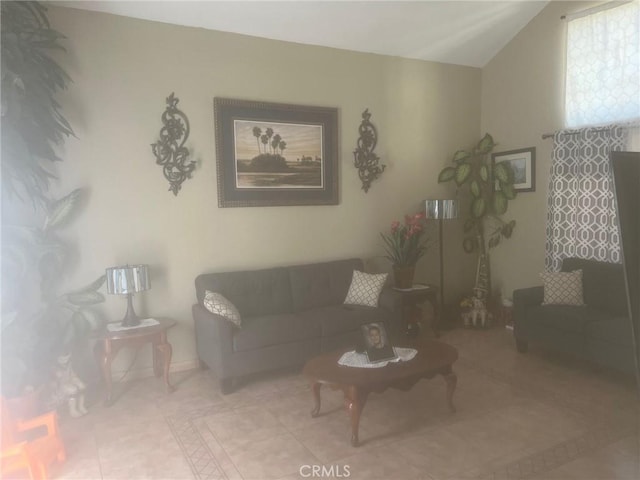 tiled living room featuring lofted ceiling