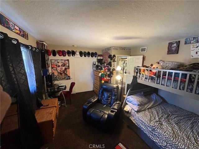 carpeted bedroom with a textured ceiling