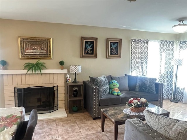 living room with tile patterned floors and a brick fireplace