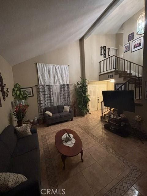 living room featuring tile patterned floors and vaulted ceiling