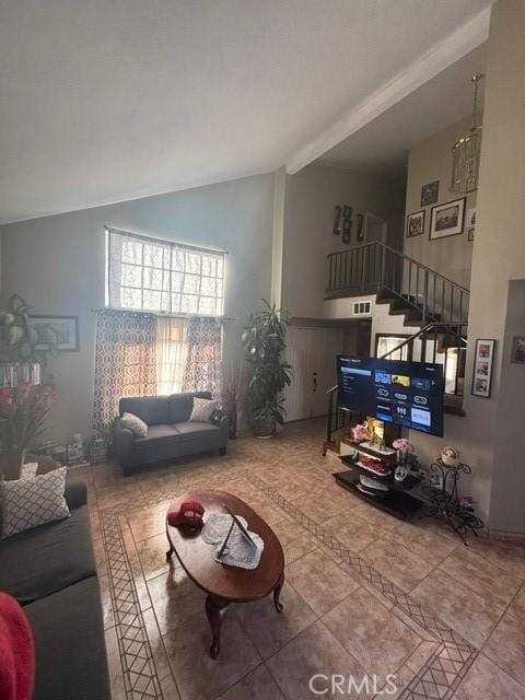 tiled living room featuring high vaulted ceiling