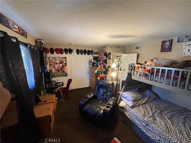 bedroom featuring carpet and a textured ceiling