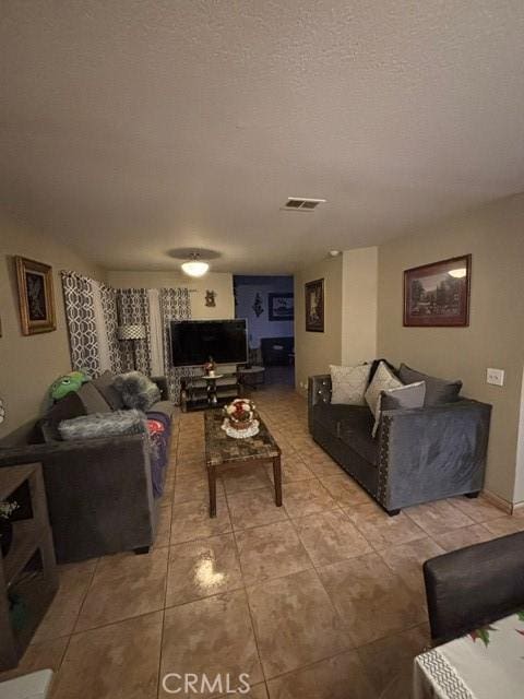 tiled living room with a textured ceiling