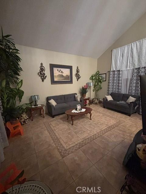 tiled living room with vaulted ceiling