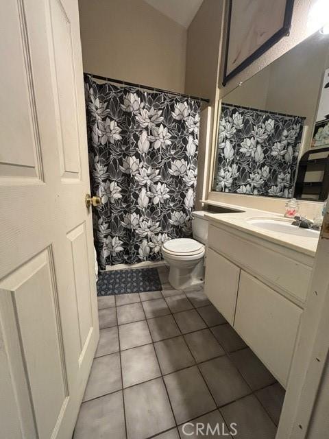 bathroom with vanity, toilet, and tile patterned flooring