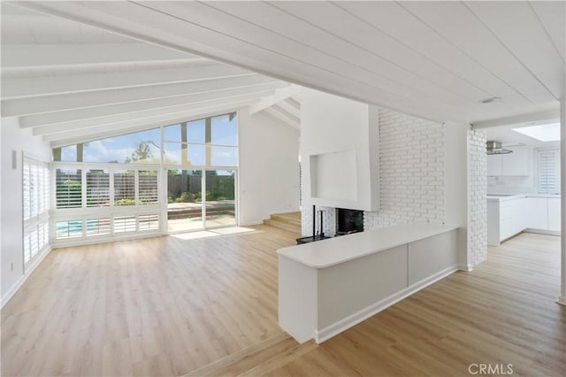 unfurnished living room with a brick fireplace, light wood-type flooring, ceiling fan, and vaulted ceiling