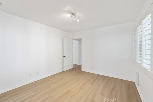 empty room with light hardwood / wood-style flooring