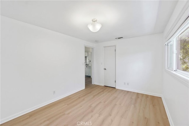 spare room with light hardwood / wood-style flooring