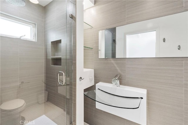 bathroom featuring tile walls, an enclosed shower, toilet, and vanity